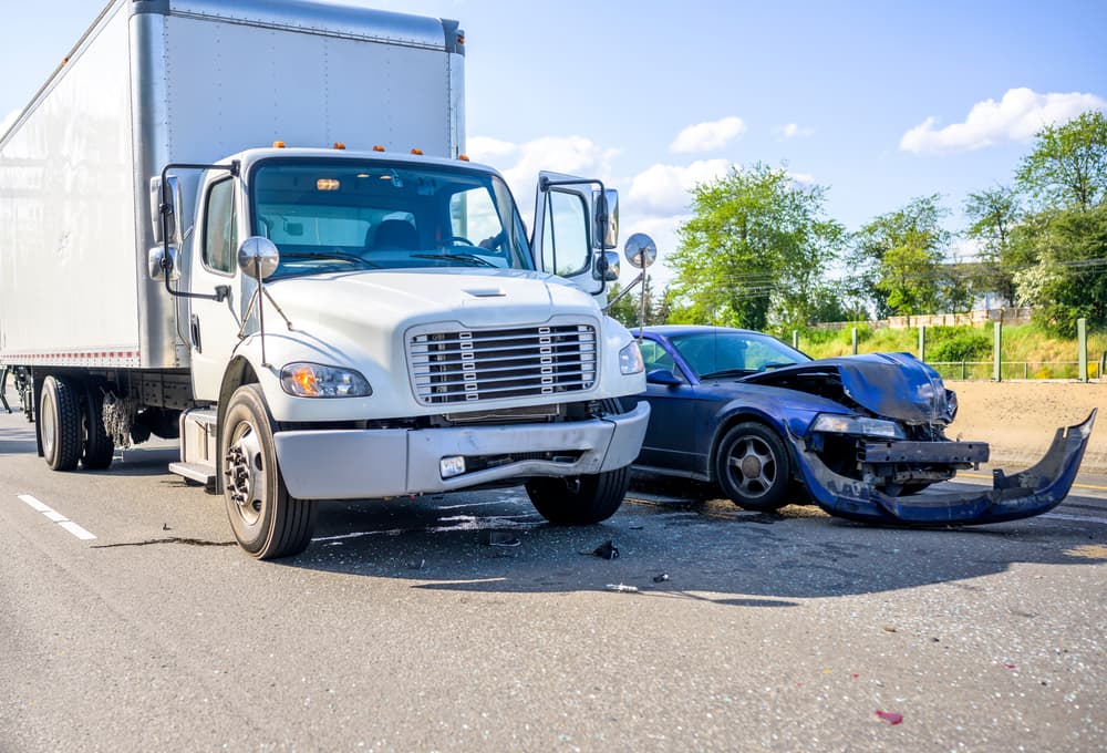 Collision between a truck and car due to blind spot