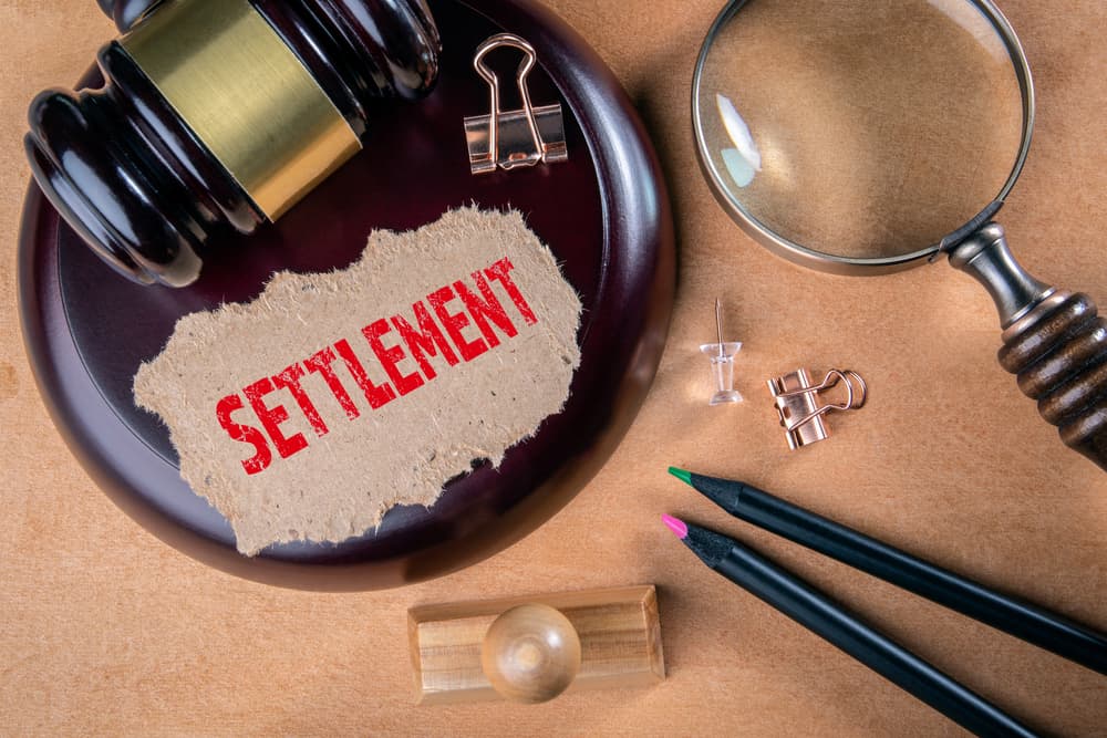 Wooden court hammer and magnifying glass on the table