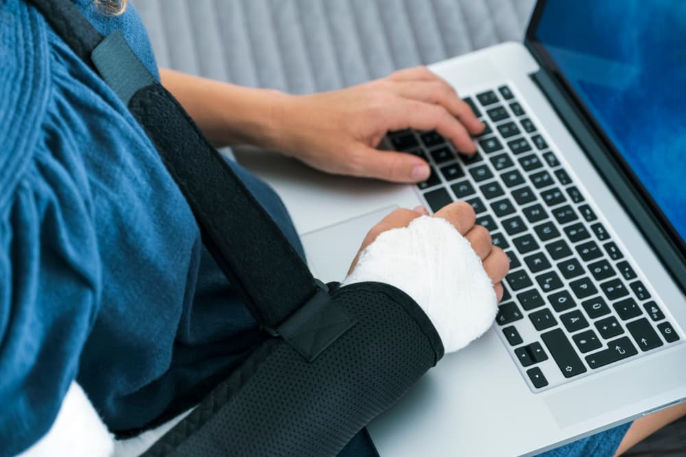 A Woman is working with her injured arm